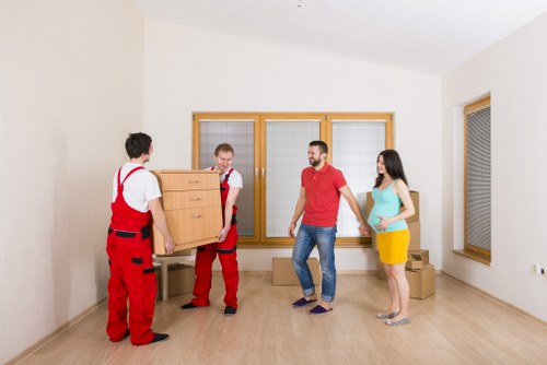 Organised moving boxes labelled for rooms in a Putney property